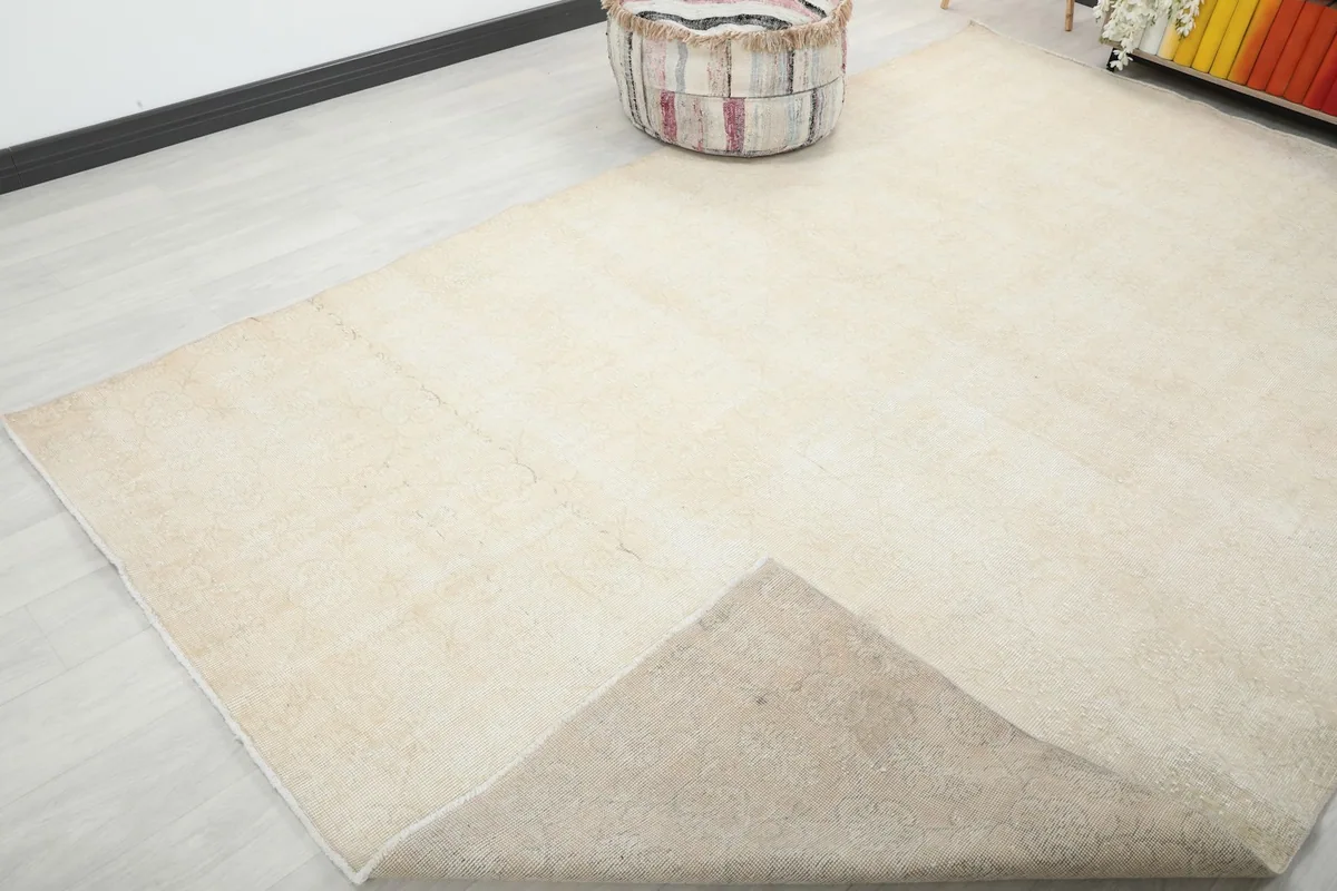 Partial view of the rug's back, revealing the cotton foundation and hand-knotted construction