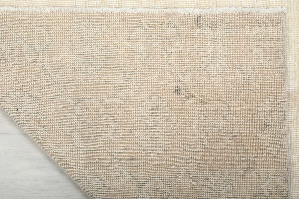 Close-up of the rug's underside, showing the intricate knotting on the cotton foundation
