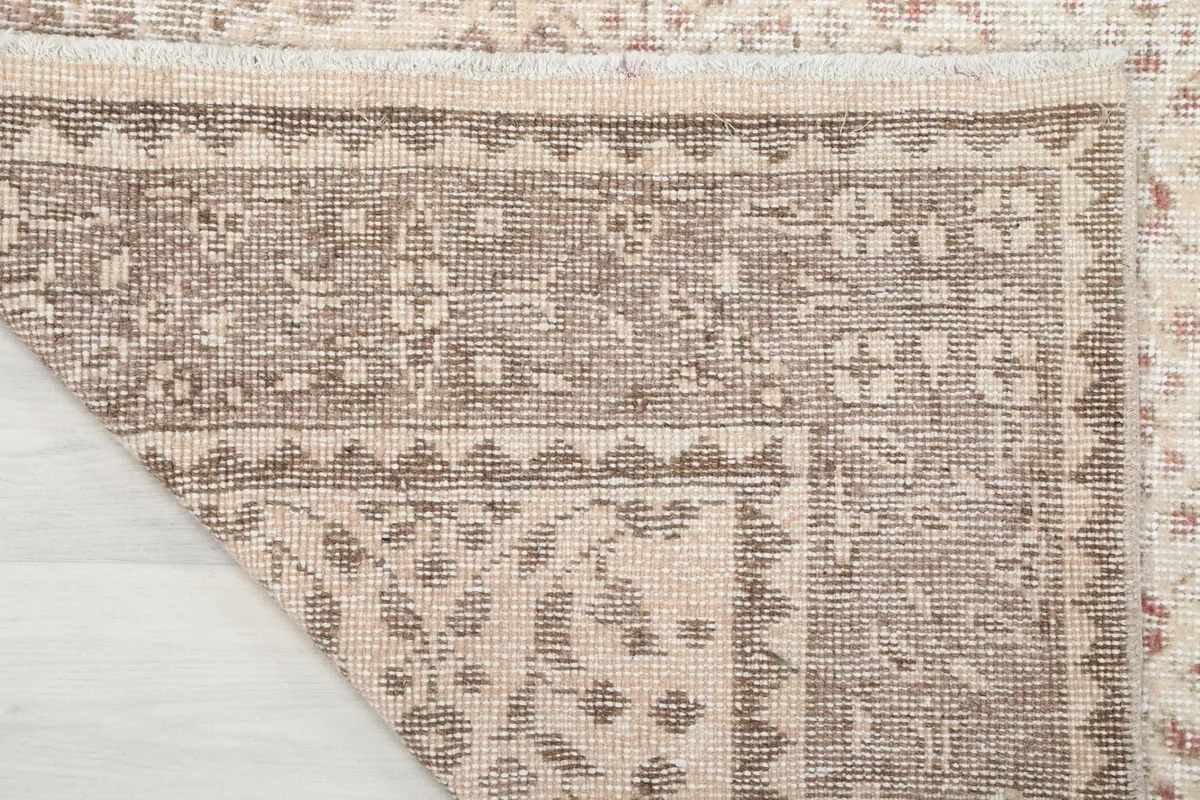 Underside view of the hand-knotted wool pile on cotton foundation of the rug
