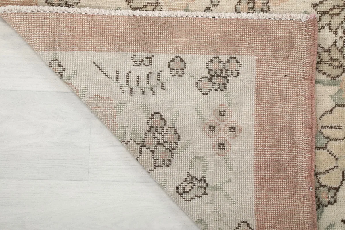 Close-up of the back of the rug, showing the cotton foundation and knotting