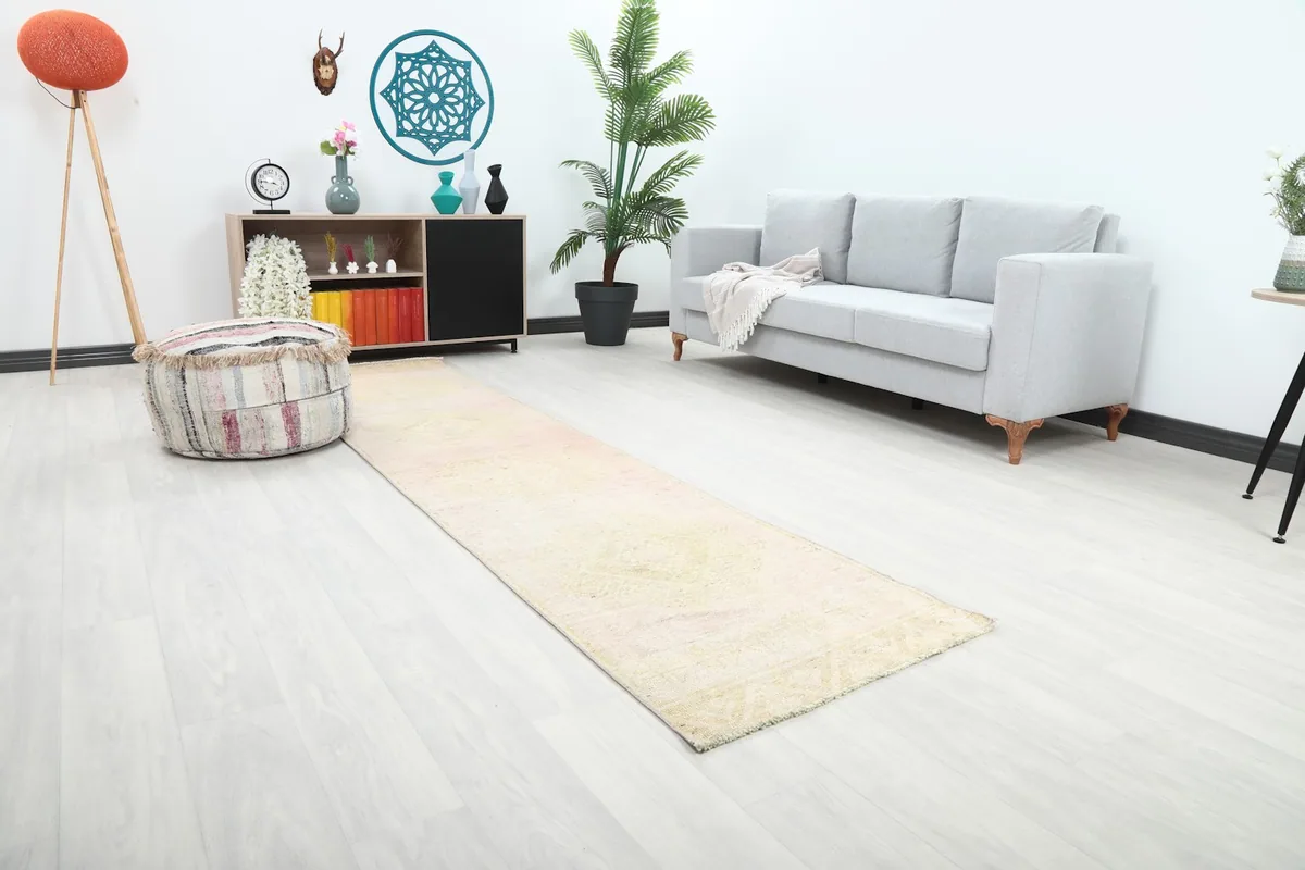 Angle view of the rose and cream runner rug extending through a contemporary living area