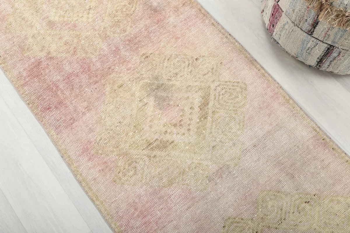 Detailed view of the rug's surface, revealing the subtle geometric motifs and color variations