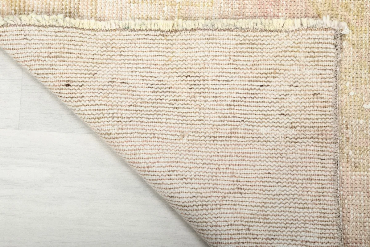 Underside of the vintage runner rug, showcasing the sturdy cotton foundation and weave
