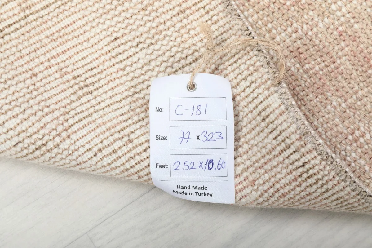 Rug tag displaying the item number, size in centimeters and feet, and 'Hand Made in Turkey'
