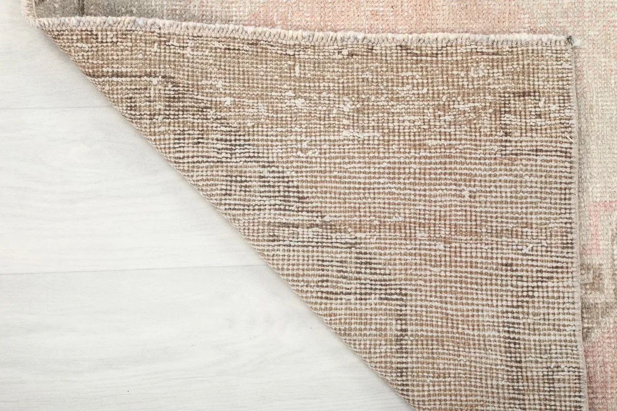 View of the back of the hand-knotted rug, showing the cotton foundation and knotting detail.