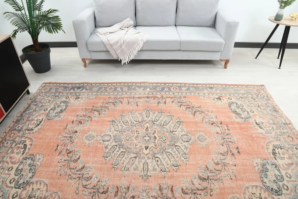 Overhead view of the orange vintage rug in a room, highlighting the central medallion