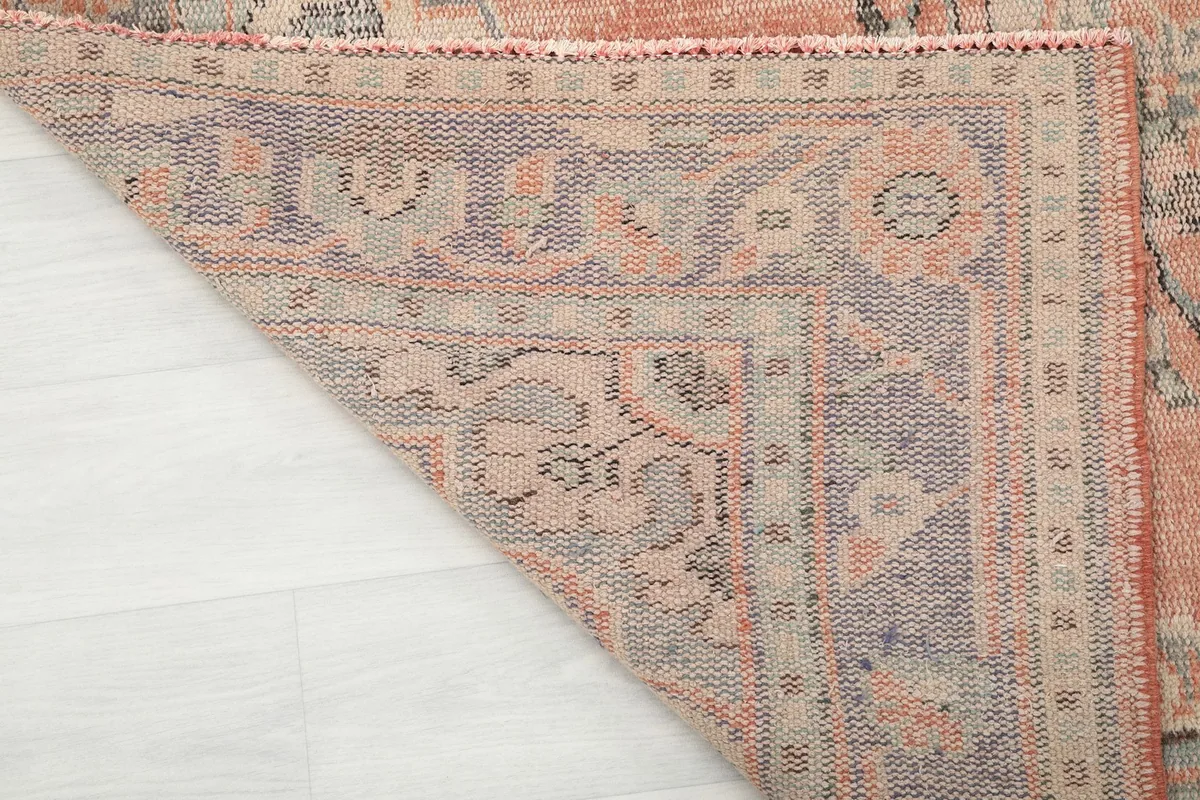Close-up of the back of the hand-knotted wool rug, revealing the foundation and knots