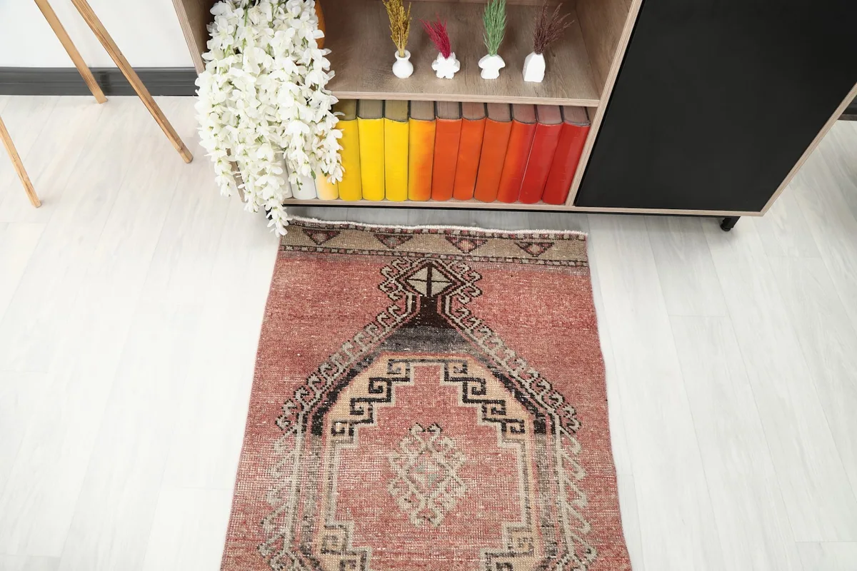 Partial view of the runner rug's end, showing its placement near a cabinet