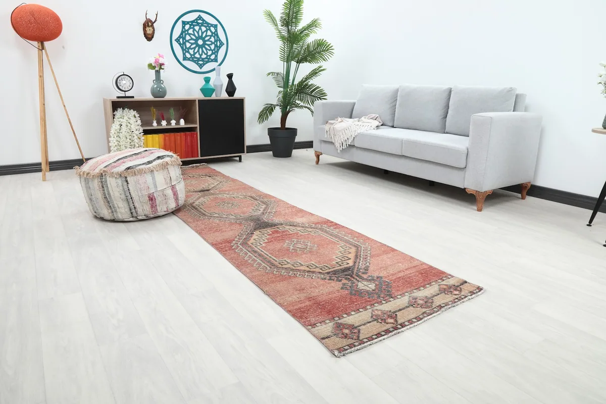 Long view of the rose runner rug extending through a modern hallway with home decor