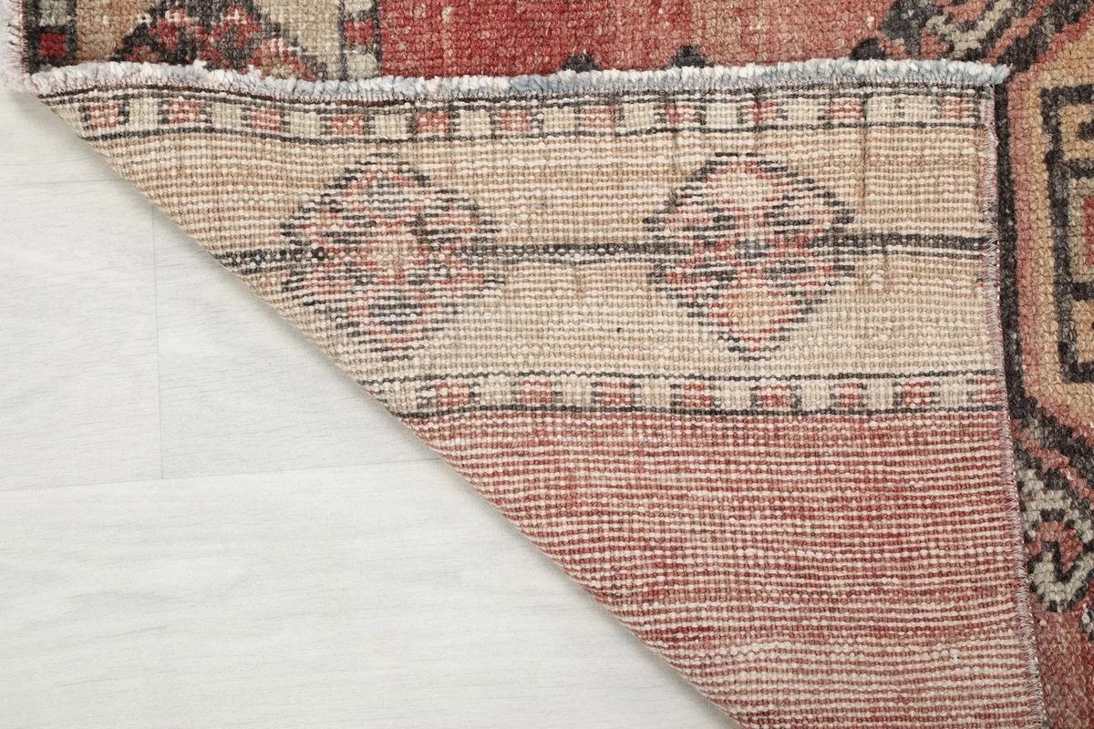 Underside view of the hand-knotted cotton foundation and the back of the wool pile