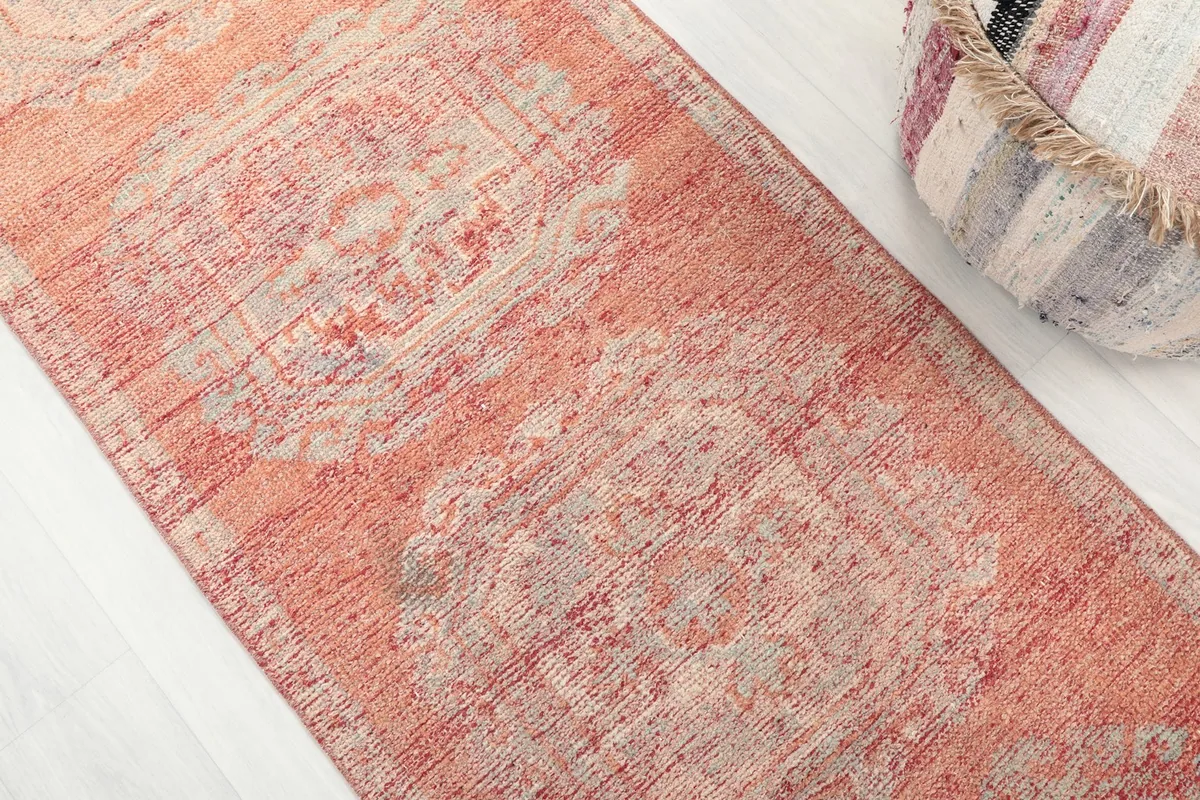 Angled close-up of the runner's surface, highlighting the distressed texture and medallion details