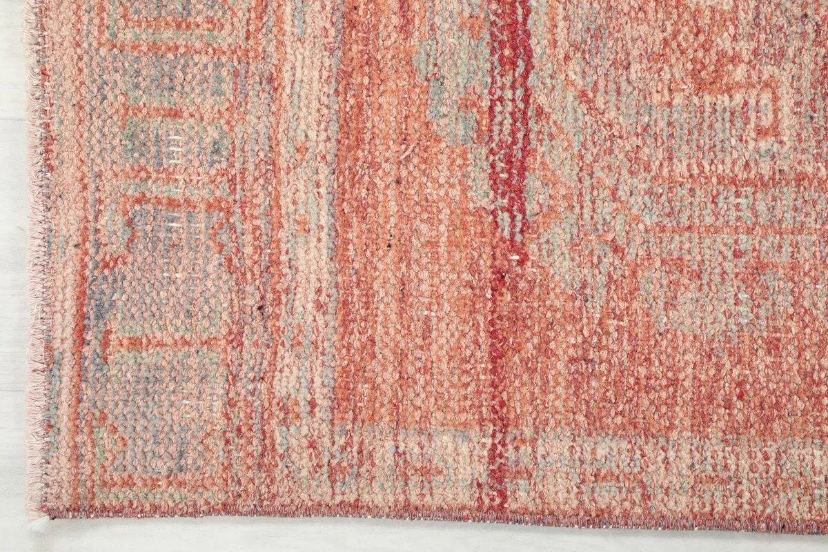 Close-up of the edge and border design of the soft rust Anatolian runner