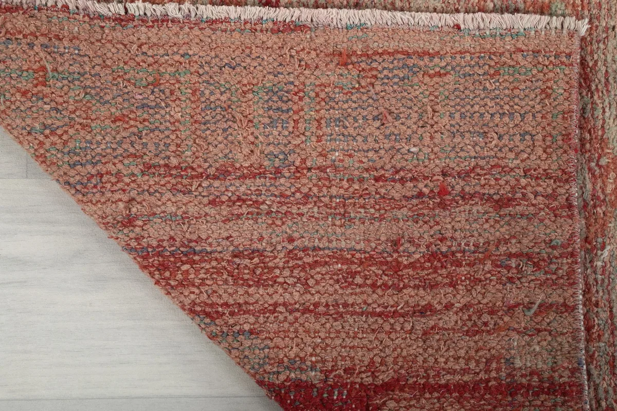 Underside of the runner rug, revealing the tightly woven cotton foundation and knotting