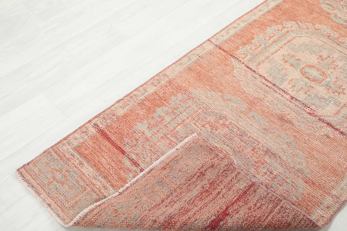 Corner of the runner folded back to show the thickness and texture of the hand-knotted construction