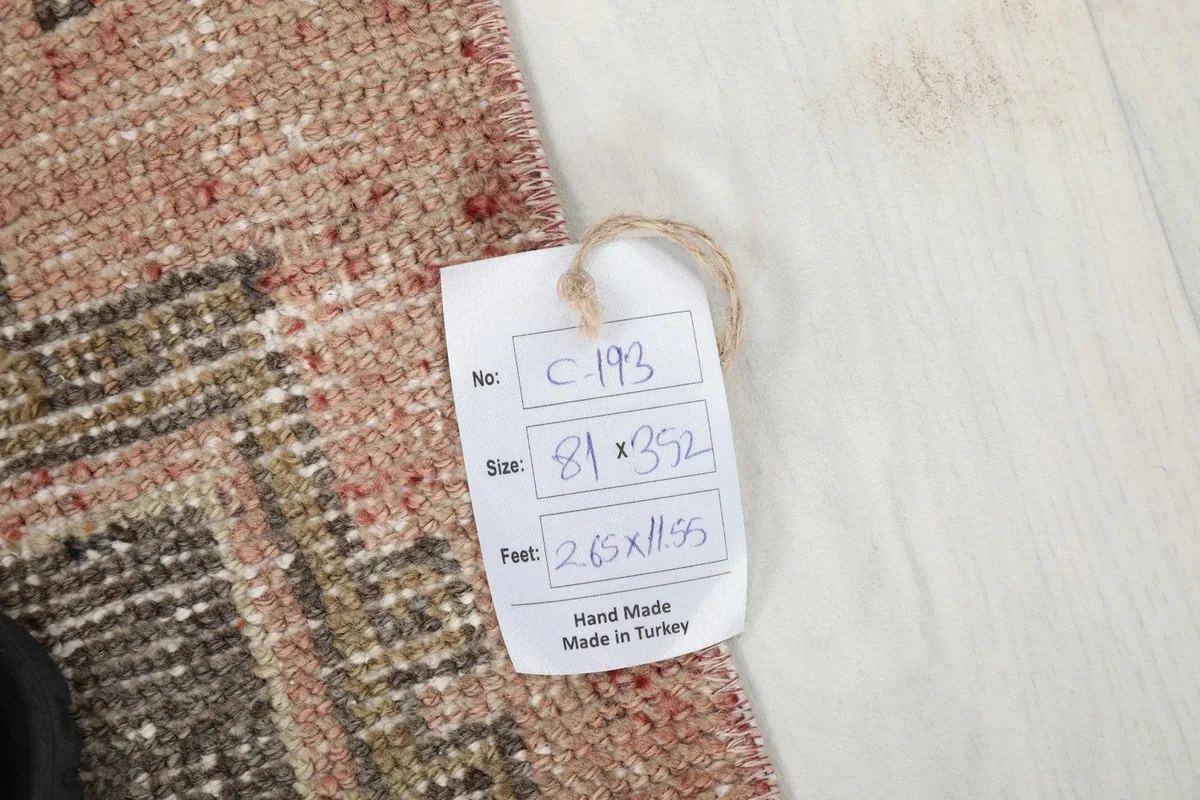 Product tag displaying the rug's dimensions in centimeters and feet, confirming its origin from Turkey.