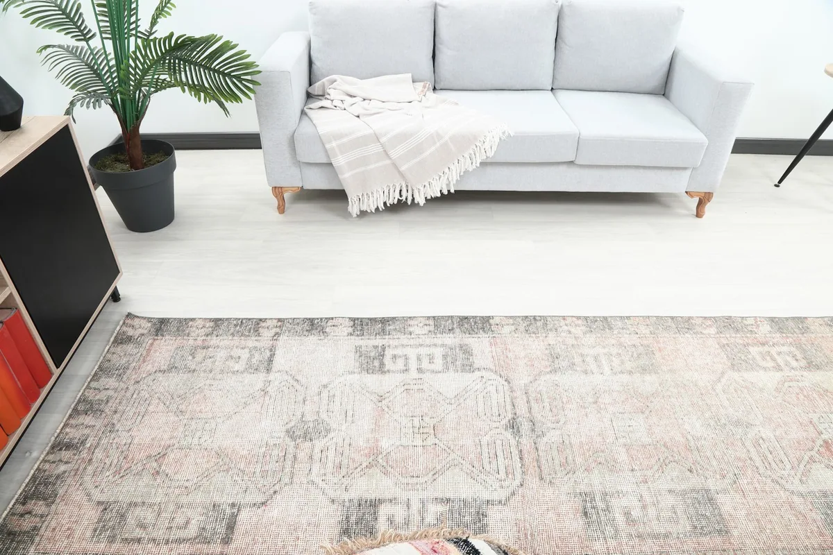Overhead view of the runner rug in a room, showing its texture and colors near a gray sofa.