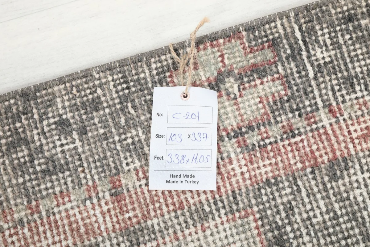 Rug tag displaying the dimensions 103 x 337 cm and origin 'Made in Turkey'.