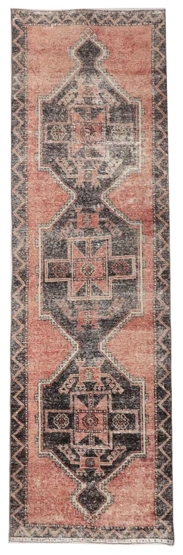 Full overhead view of the rust and charcoal geometric vintage runner on a white background