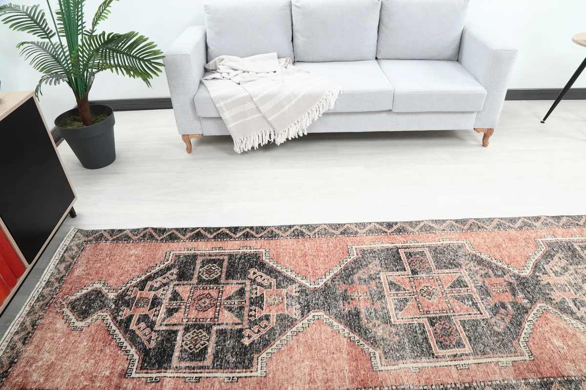Overhead view focusing on the runner's length and pattern in front of a grey sofa