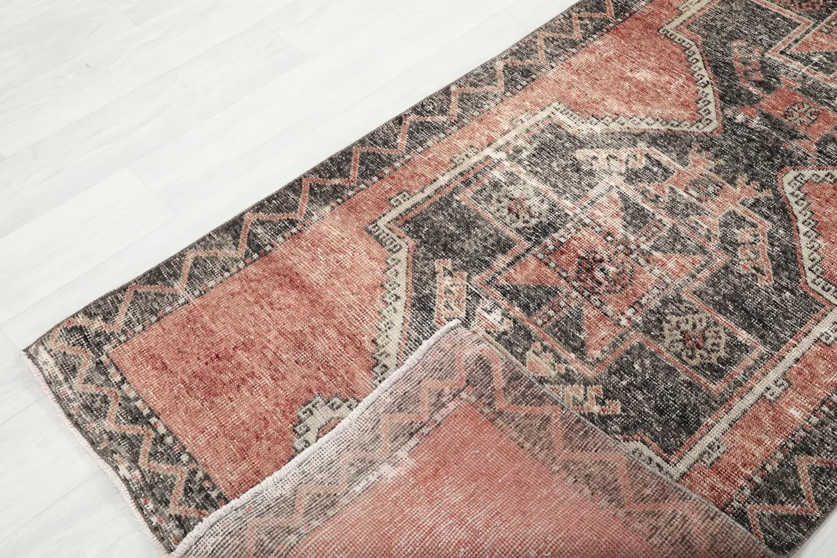 View of the low wool pile and the reverse side of the runner, indicating its hand-knotted nature