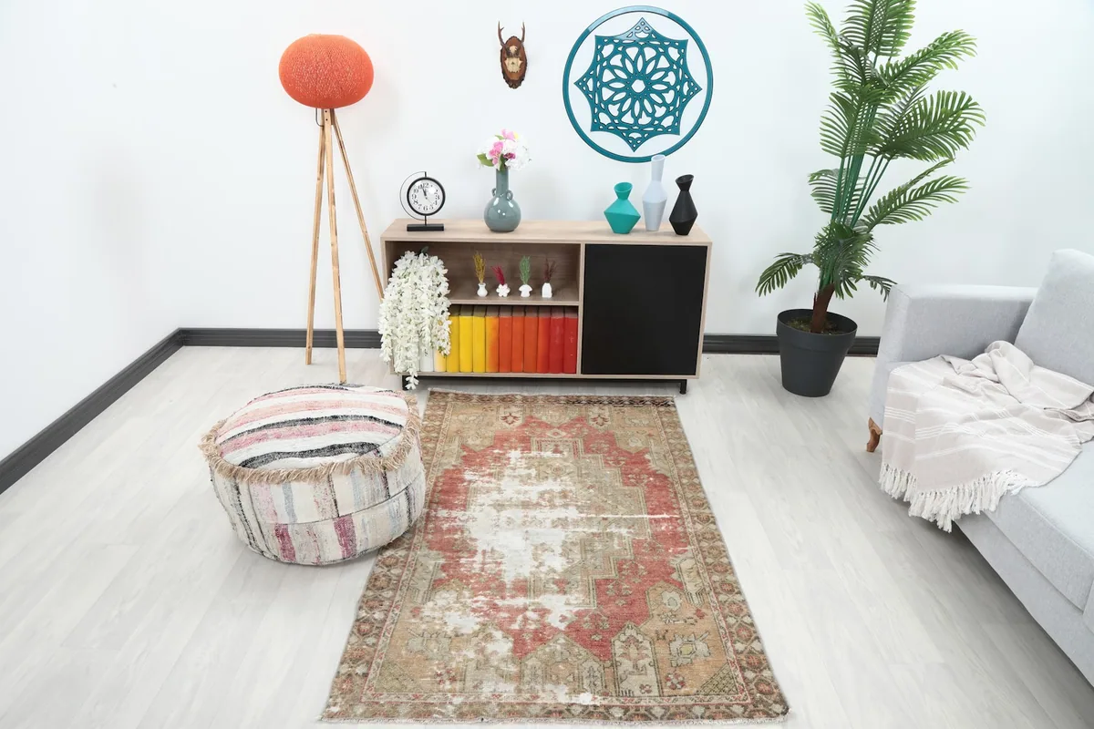 Vintage rose and beige Anatolian rug displayed in a modern living room setting
