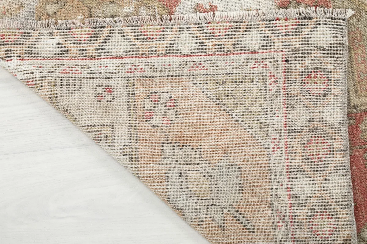 Close-up of the rug's reverse side, revealing the hand-knotted construction and foundation