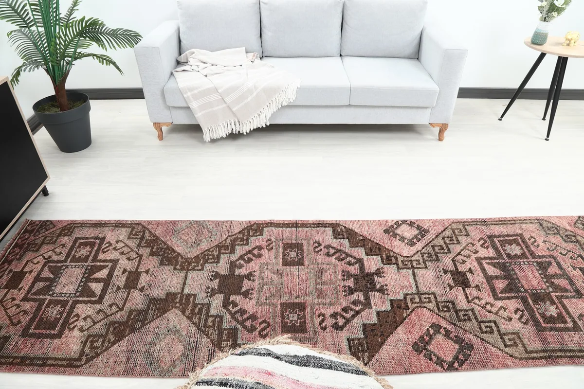 Overhead view of the rose runner rug extending from a sofa towards a bookshelf