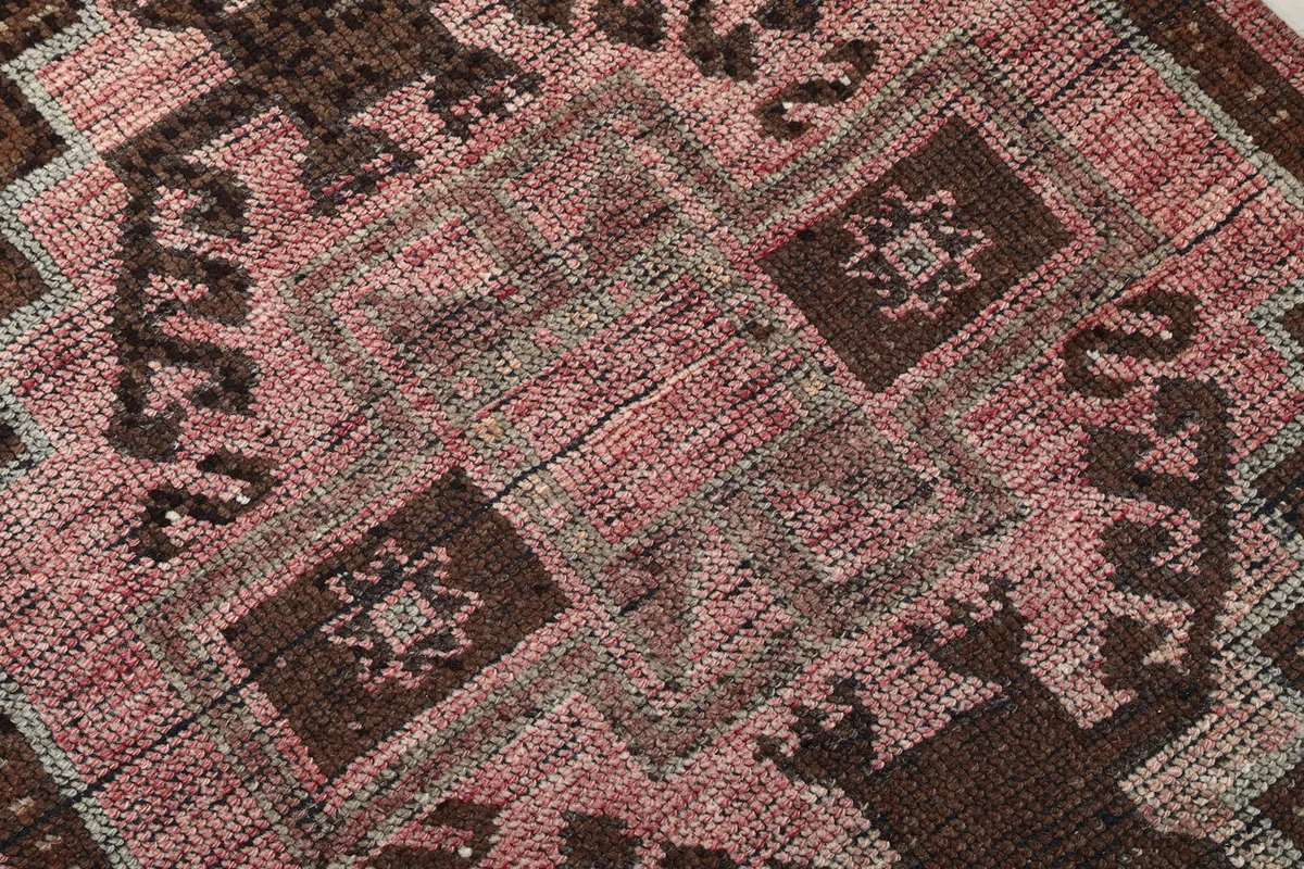 Close-up detail of the hand-knotted wool pile and intricate geometric motifs