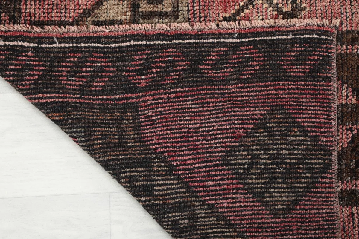 Close-up of the back of the hand-knotted runner rug, showcasing the cotton foundation