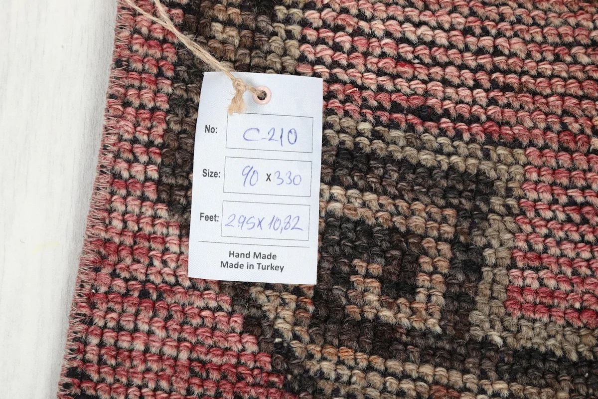 Product tag attached to the runner rug, displaying size and origin information