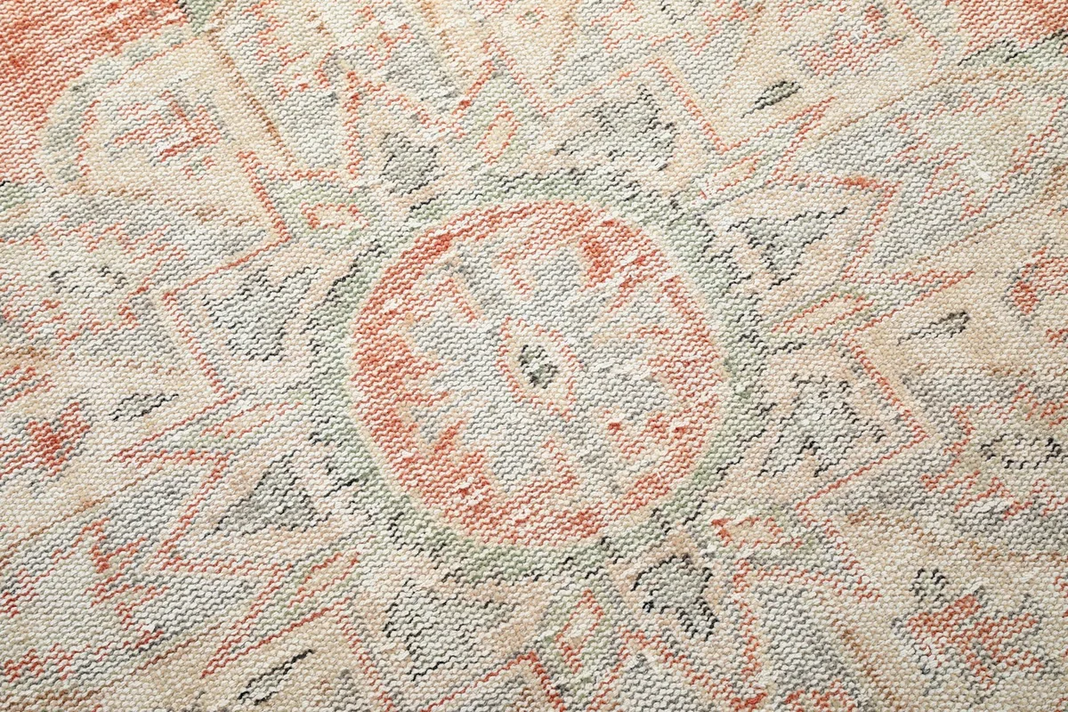 Close-up detail of the hand-knotted wool pile, showing the geometric patterns and colors