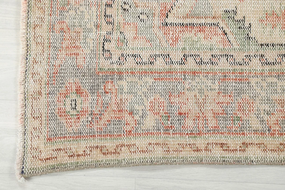 Detailed view of the rug's border design and edge, showcasing the craftsmanship