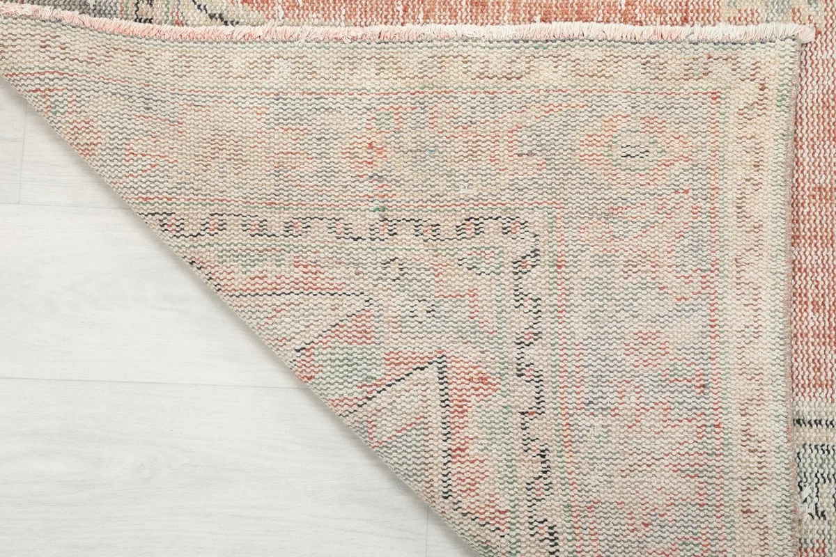 Underside of the hand-knotted rug, showing the cotton foundation and knotting detail