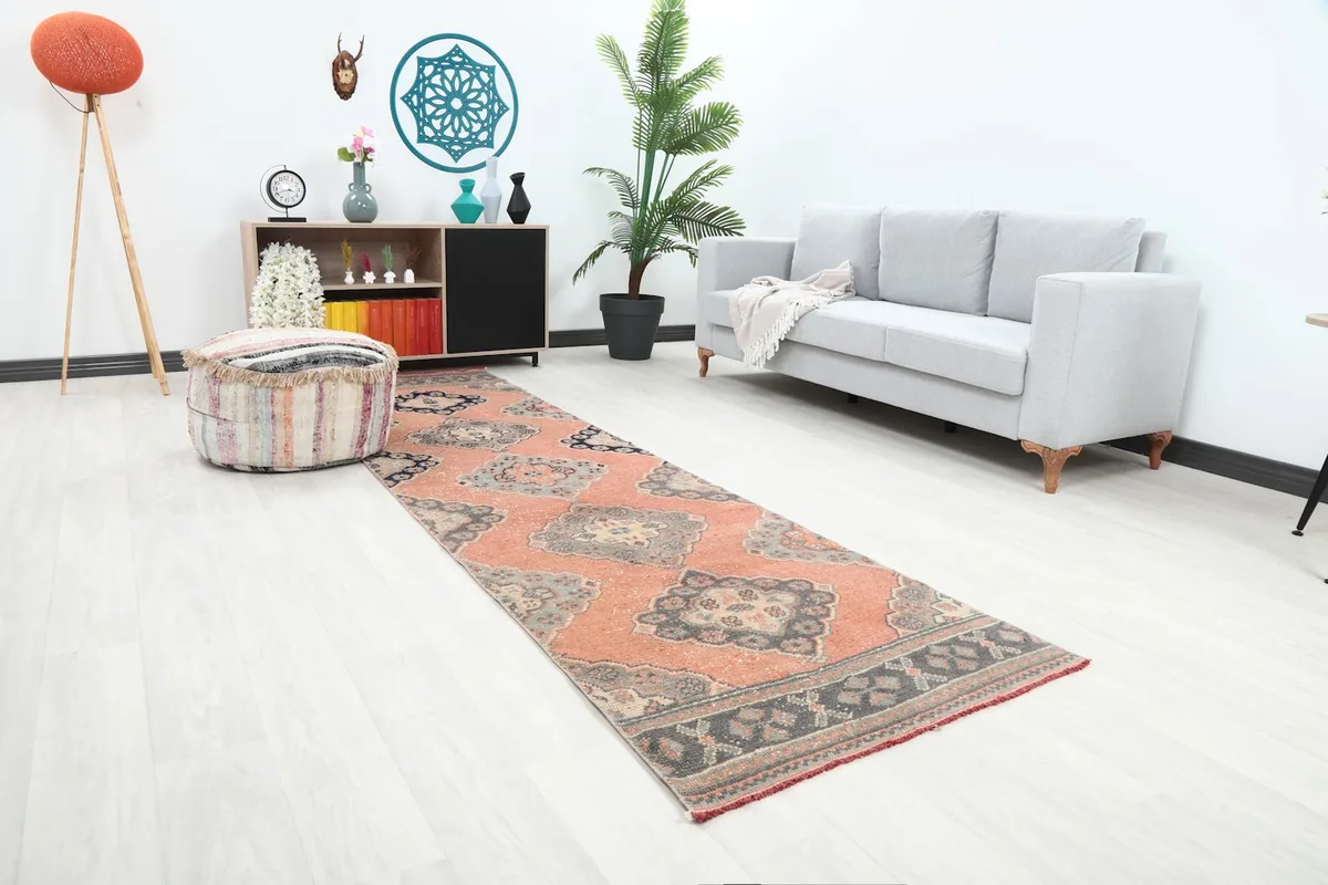 Angle view of the rust runner rug in a living space, showing its length and how it complements the decor.