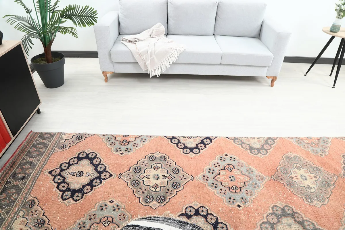 Overhead view showing the middle section of the rust runner rug with its geometric medallion pattern.