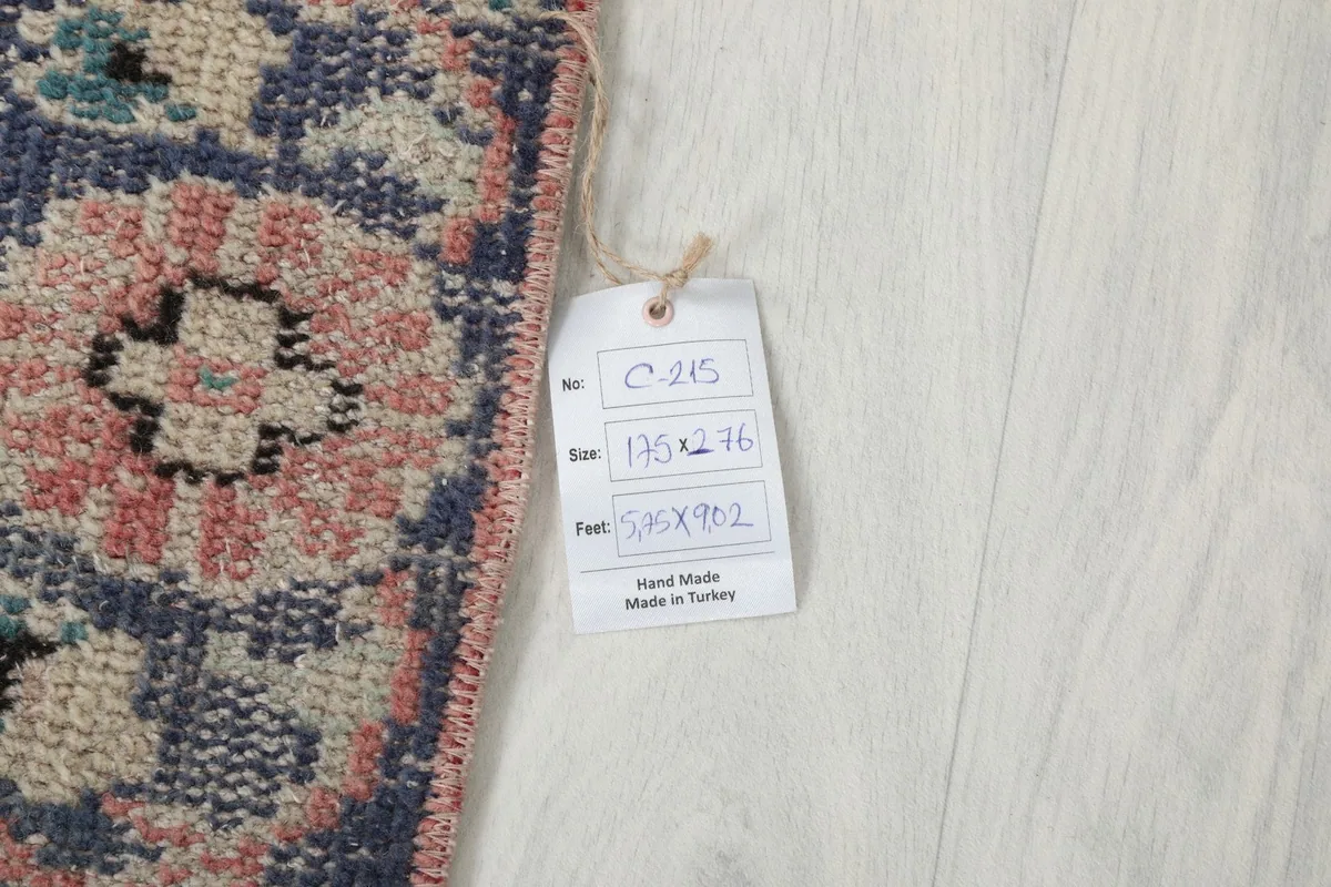 Tag showing the rug's size in centimeters and feet (175 x 274 cm / 5'9" x 9'0"), confirming hand-made in Turkey.