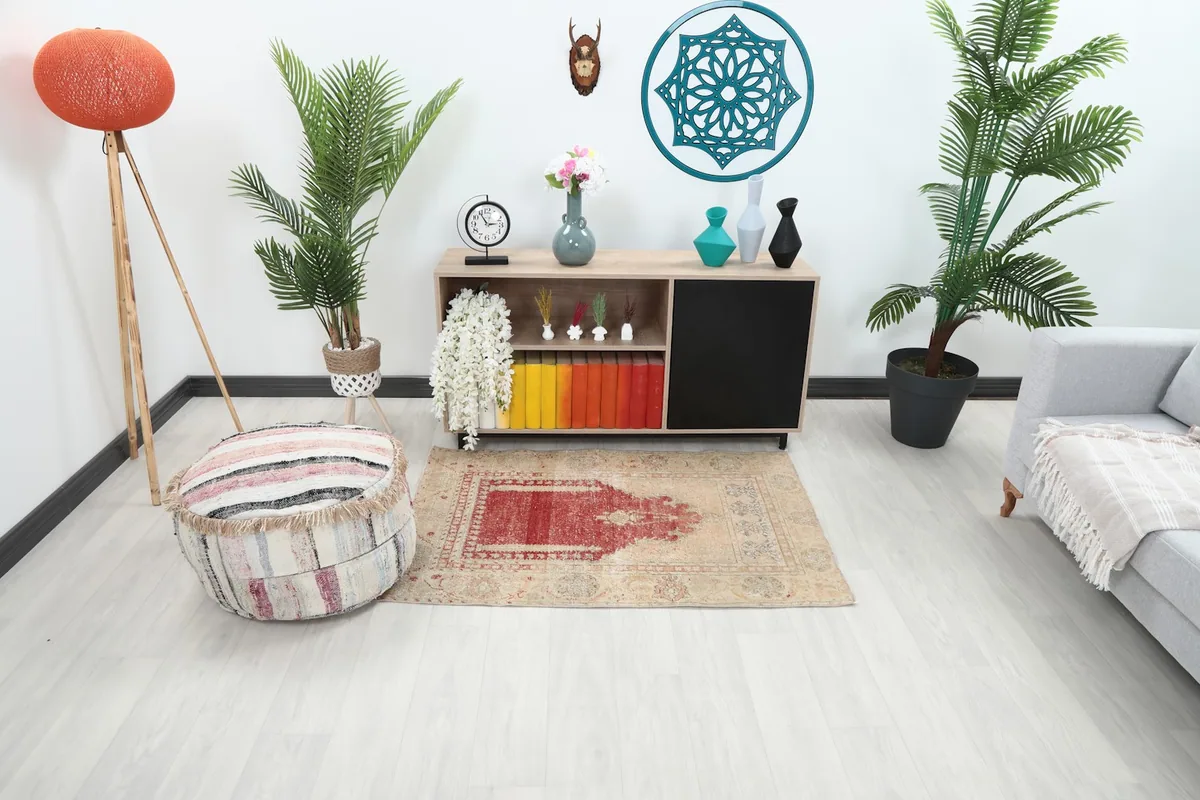 Vintage Anatolian rug with rust mihrab design styled in a modern living room setting.