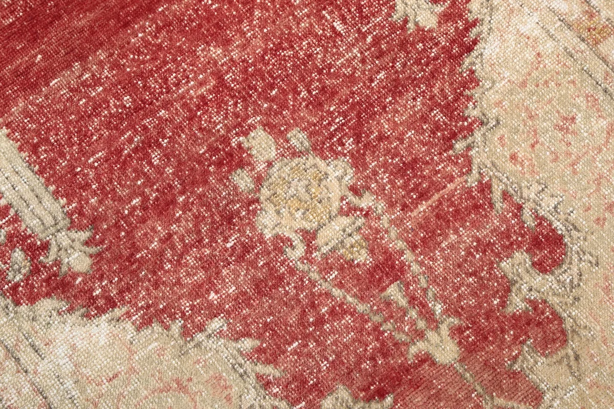 Detailed close-up of the rust central field and faded patterns within the mihrab motif.