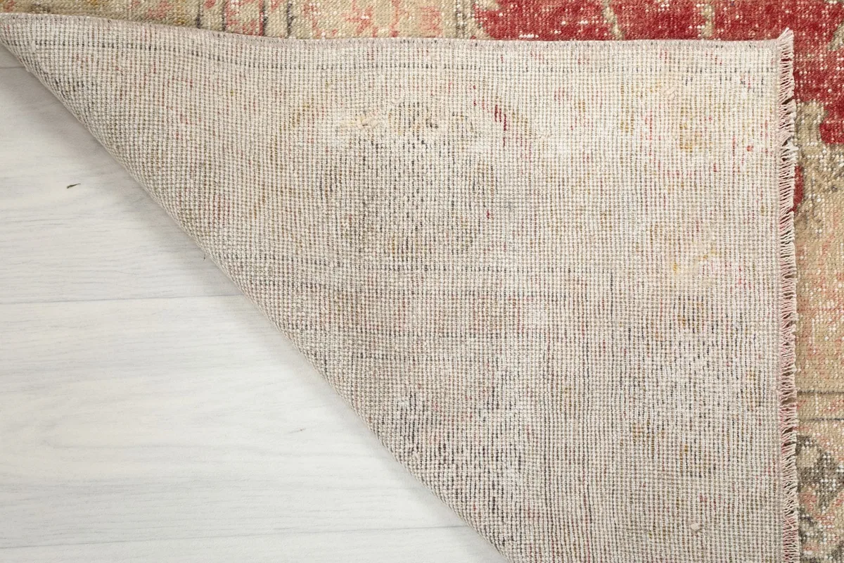 Underside view of the rug, revealing the tight hand-knotted construction and natural foundation.