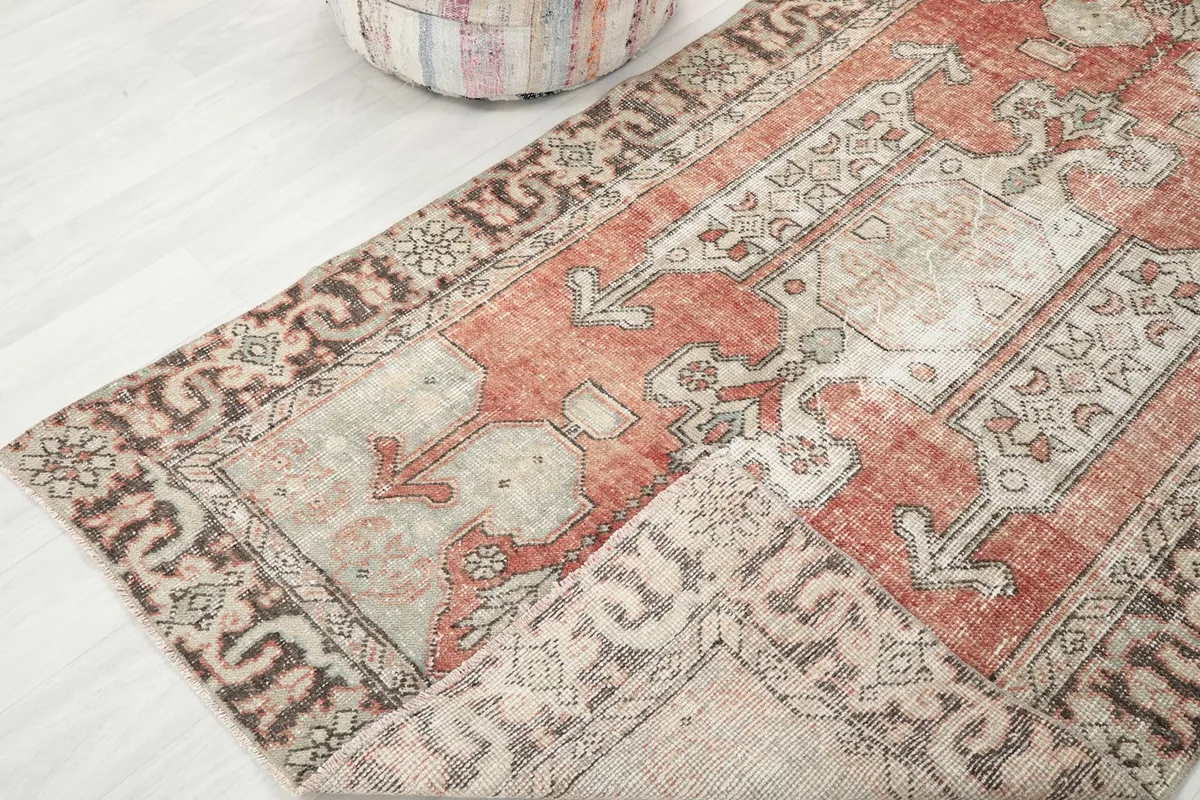 Folded corner of the rug, revealing the thickness and density of the hand-knotted material