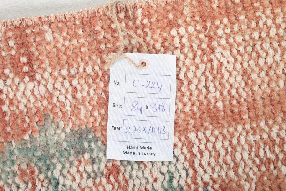 Close-up of the product tag attached to the vintage Anatolian runner rug