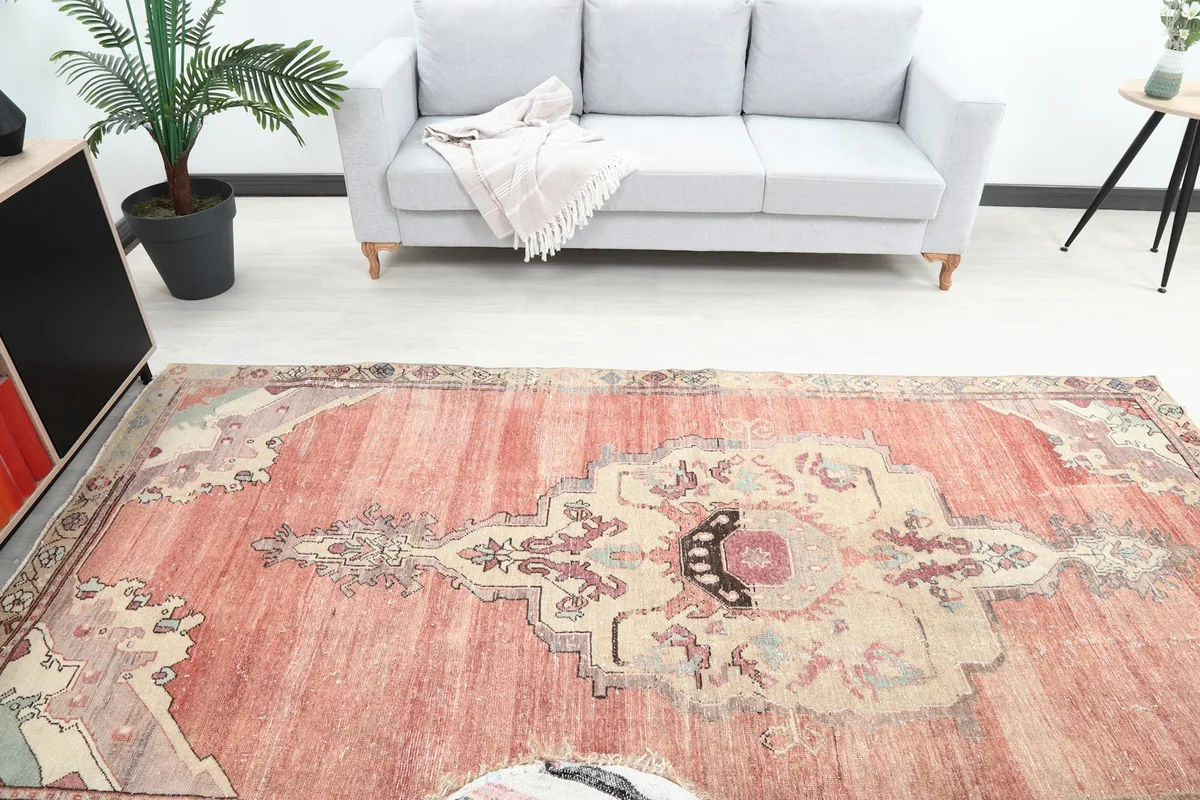 Overhead view of the rug in a room, capturing the central medallion and surrounding decor.