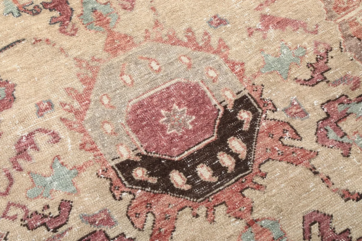 Close-up of the intricate patterns and colors within the medallion of the vintage Anatolian rug.