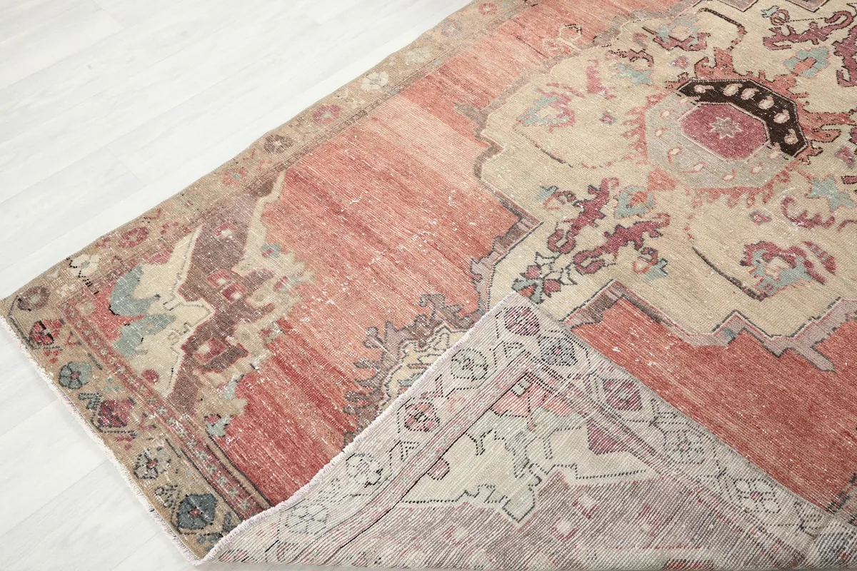 View of the rug folded back, revealing the wool pile and cotton foundation.