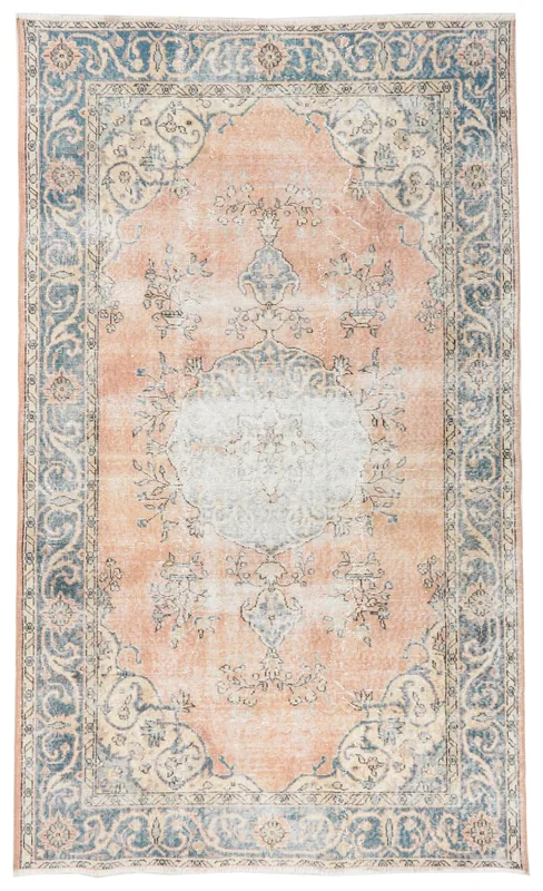 Full overhead view of the rust and blue vintage Anatolian rug with a central medallion.