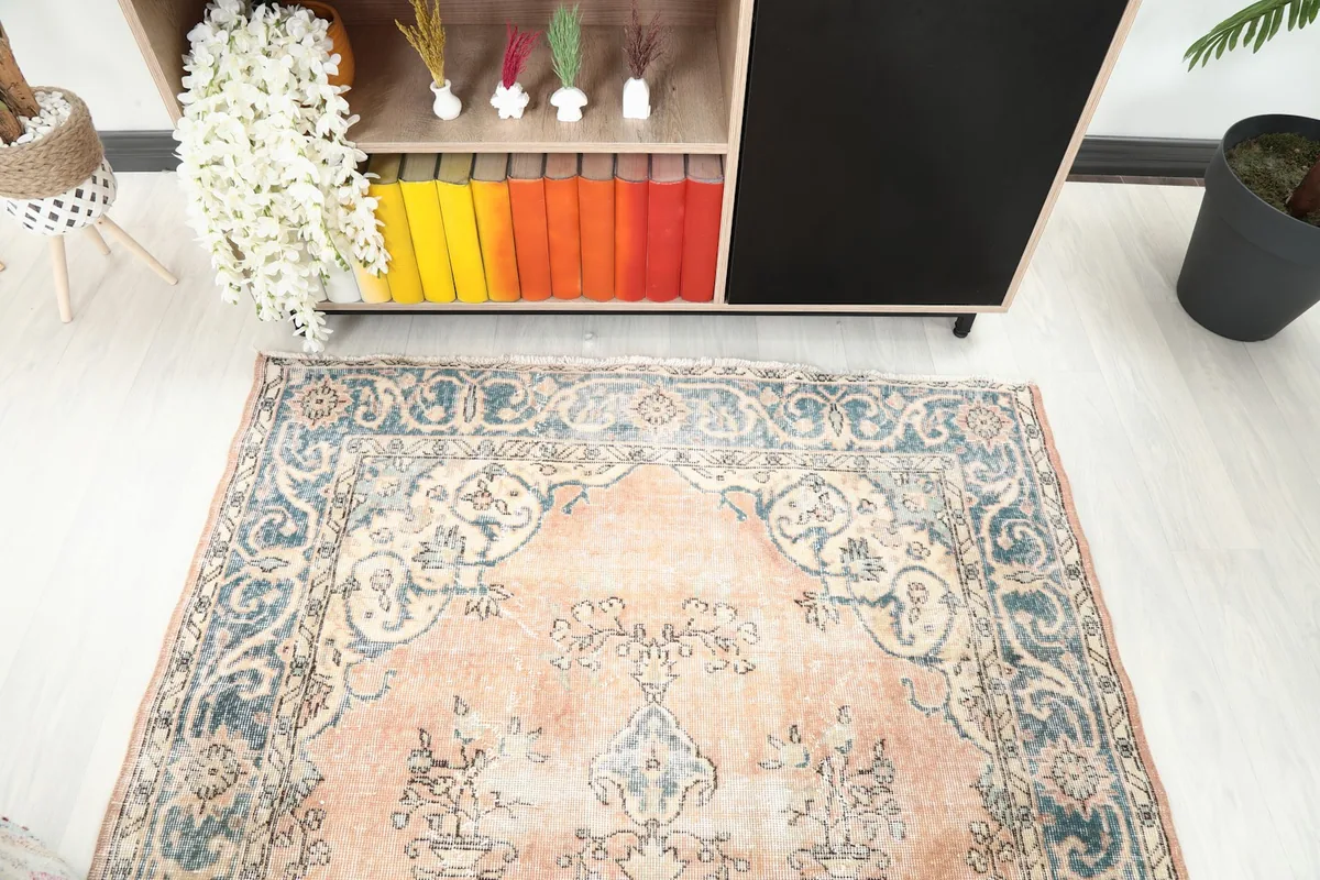 Angled view looking down at the rug, highlighting the medallion and floral patterns.