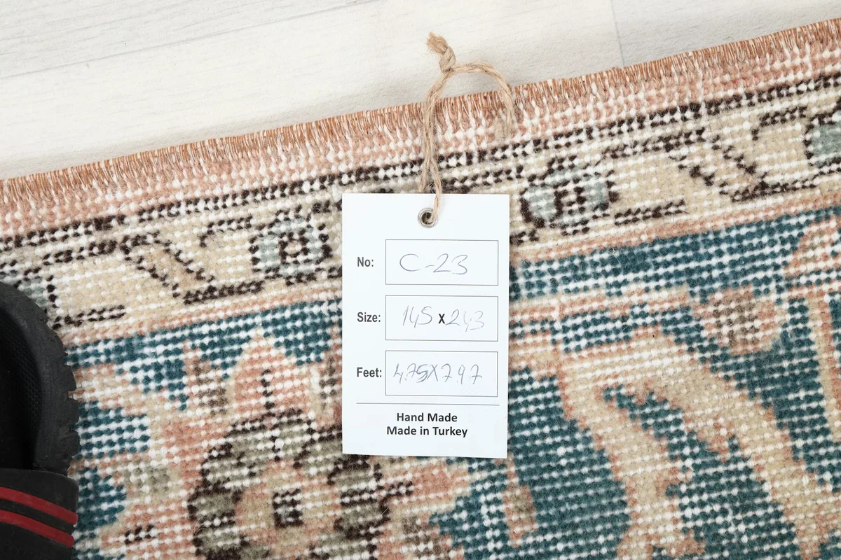 Close-up of the rug's edge with a product tag displaying size and origin details.