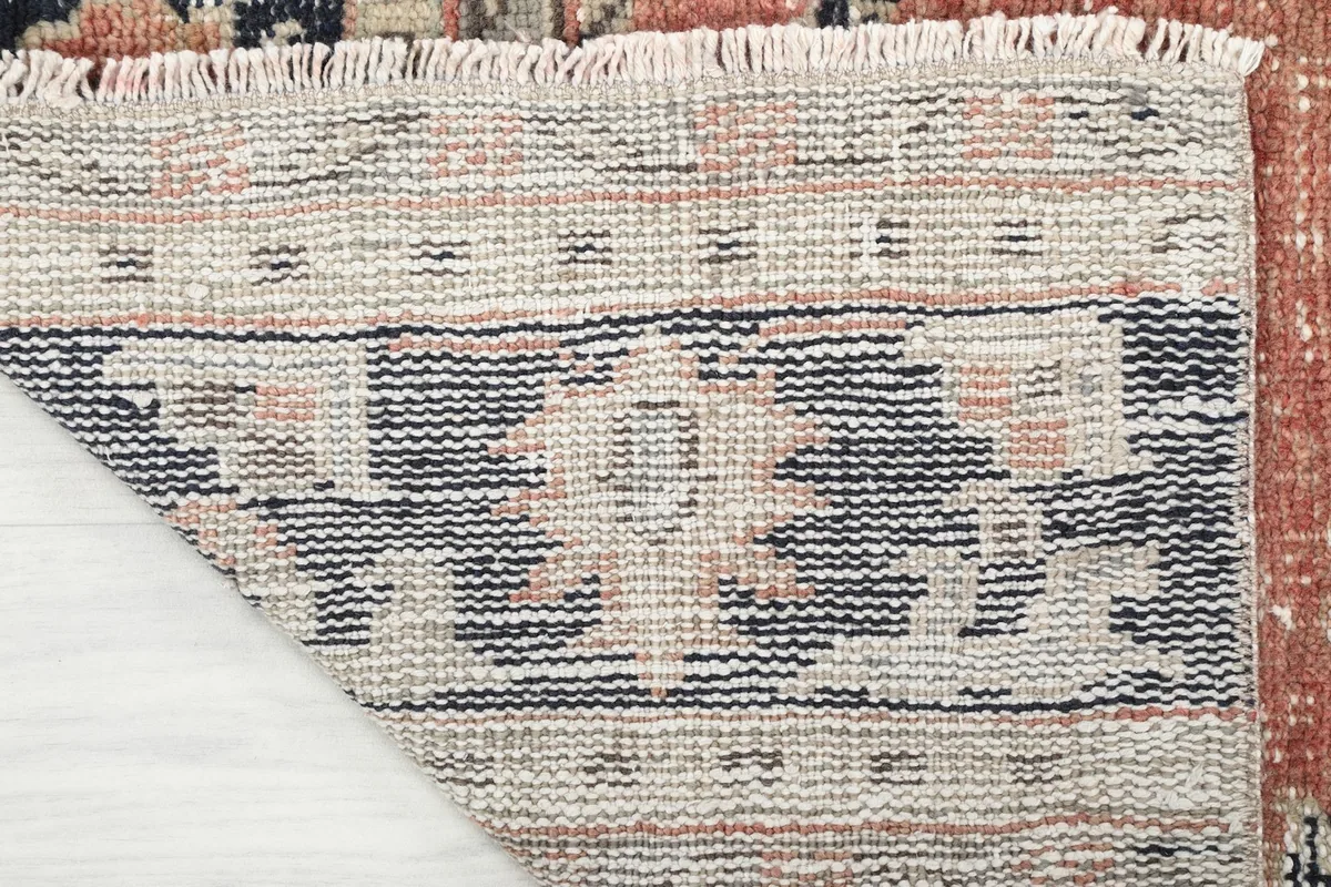 Close-up of the reverse side of the rug, showing the cotton foundation and hand-knotted construction
