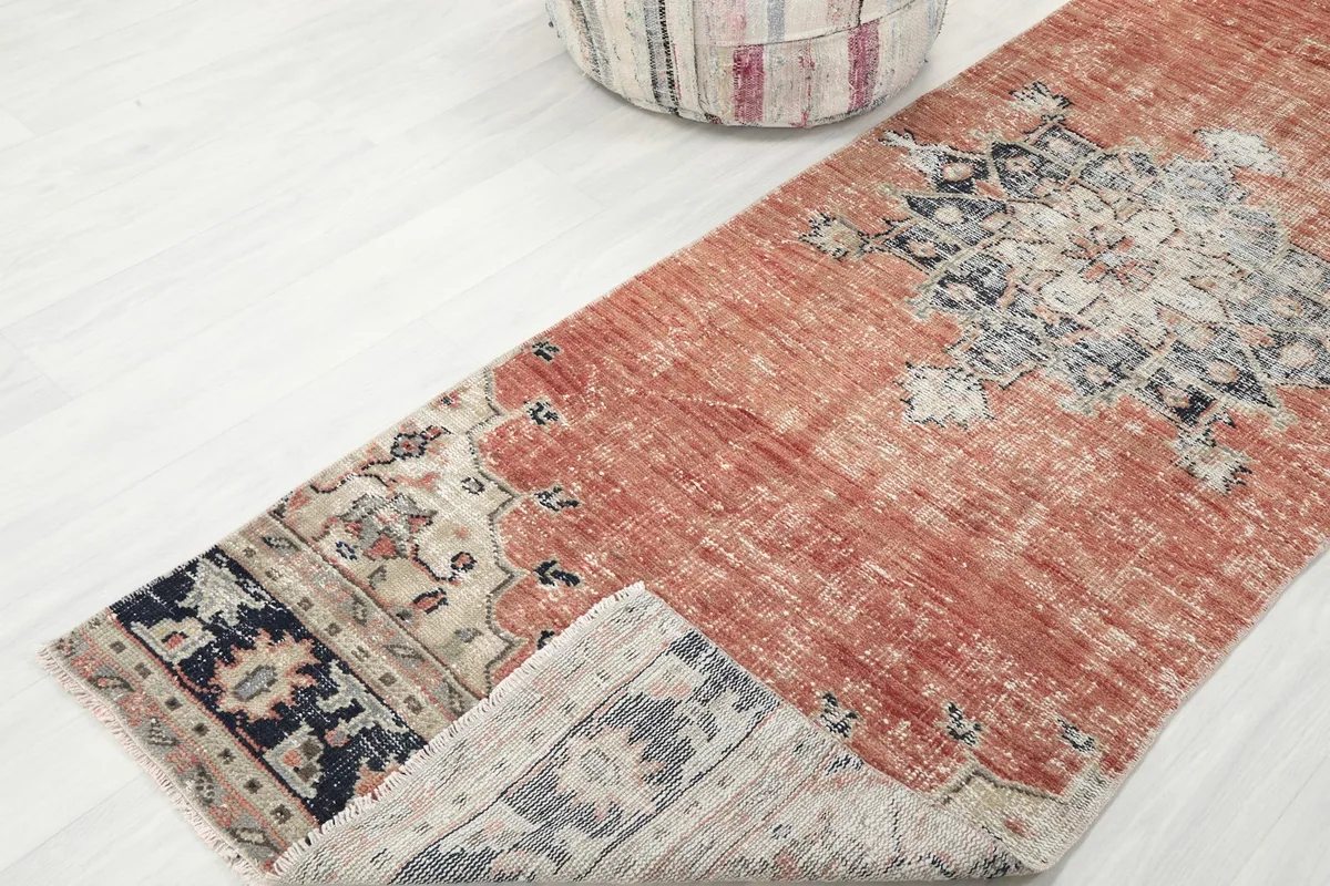 The runner partially folded, revealing the wool pile on the cotton foundation and its thickness