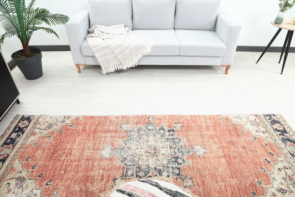 Overhead view of the runner in a room, showing its placement relative to a sofa and ottoman